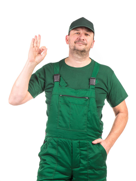 Worker in green overalls - Фото, зображення