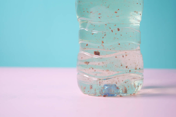 грязная бутылка воды на столе . - Фото, изображение