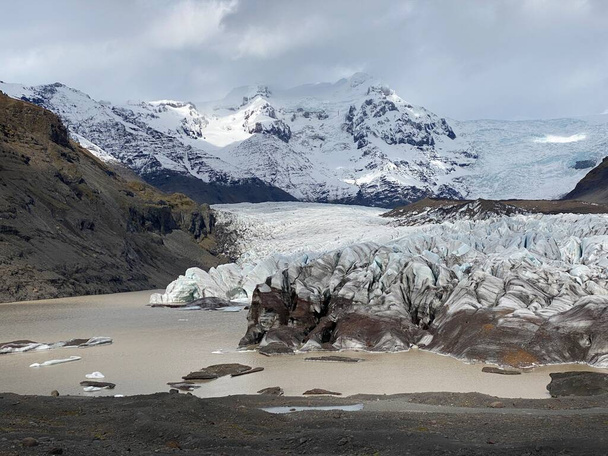 Foto generale di un ghiacciaio in Islanda, con nuvole in montagna, giornata nuvolosa. immagine orizzontale - Foto, immagini