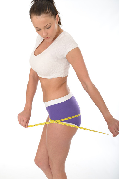 Healthy Young Woman Checking Her Weight Loss With a Tape Measure - Fotoğraf, Görsel