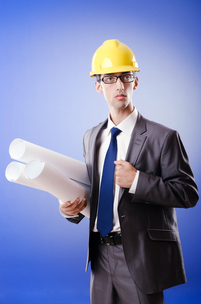 Young architect with drawings and hardhat - Φωτογραφία, εικόνα