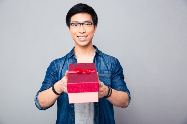 Happy young asian man with gift box - Fotografie, Obrázek