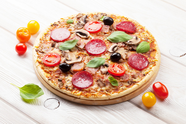 Italian pizza with pepperoni, tomatoes - Photo, Image