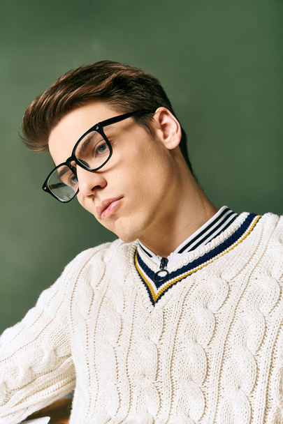 A young man in glasses and a sweater in college - Photo, Image