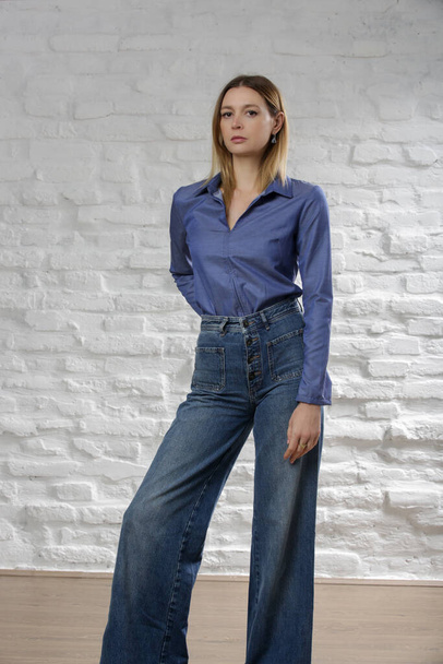 Studio photo of woman wearing cool denim on denim outfit - Photo, Image