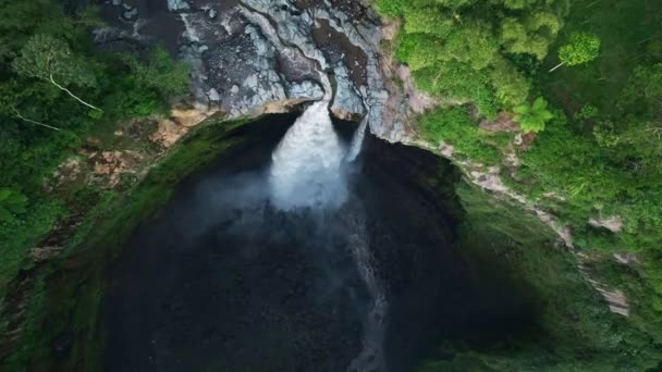 Aerial view drone flying backward and tilt up to reveal Coban Sriti waterfall, Indonesia - Footage, Video