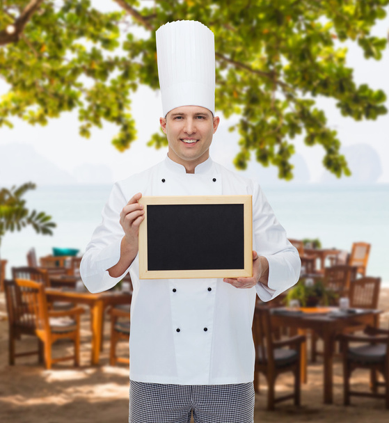 happy male chef cook holding blank menu board - Valokuva, kuva