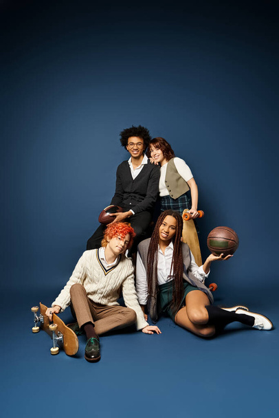 A group of young multicultural friends, including a nonbinary person, sitting together in stylish attire on a dark blue background. - Photo, Image