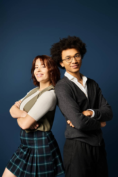 A young multicultural friends standing together in stylish attire on a dark blue background. - Photo, Image