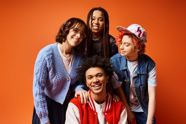 A group of young interracial friends, including a nonbinary person, standing stylishly together in a studio setting. - Photo, Image