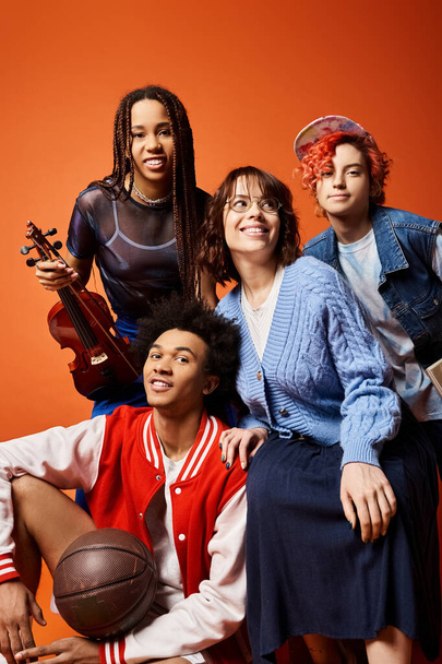 A diverse group of young friends, including a nonbinary person, pose together in stylish attire in a studio setting. - Photo, Image