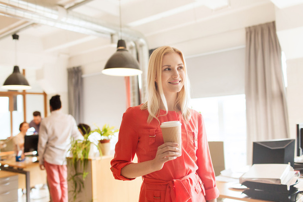 happy creative female office worker with coffe cup - Zdjęcie, obraz