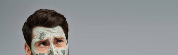 Appealing stylish man wearing a facial mask, skincare. - Photo, Image