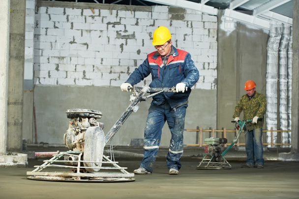 Worker trowelling and finishing of concrete - Фото, зображення