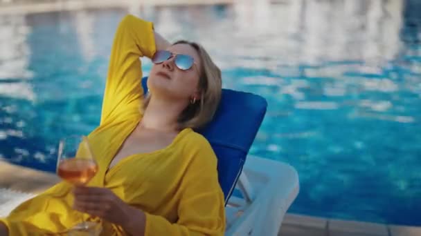 Pretty woman with wine relaxing by the pool. - Footage, Video