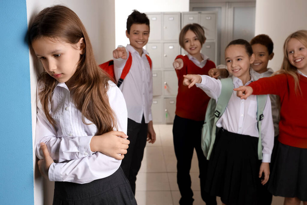 Знущання маленька дівчинка в шкільному залі - Фото, зображення