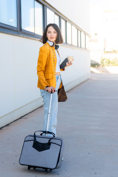 Joven mujer de negocios con maleta y café para llevar - Foto, imagen