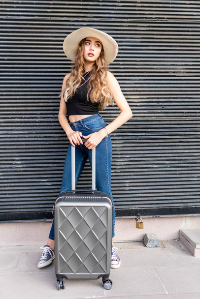young woman  in straw hat  with suitcase in city - Photo, Image