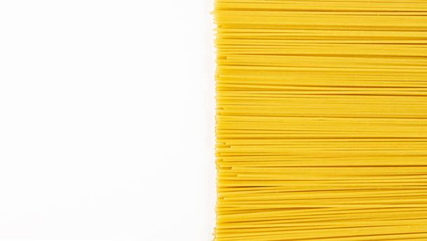 Spaghetti pasta, raw pasta on half of the white table - Photo, Image