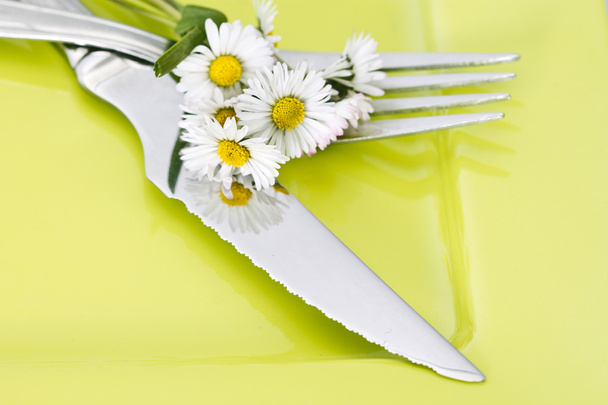 Forks with daisy bouquet on background - 写真・画像