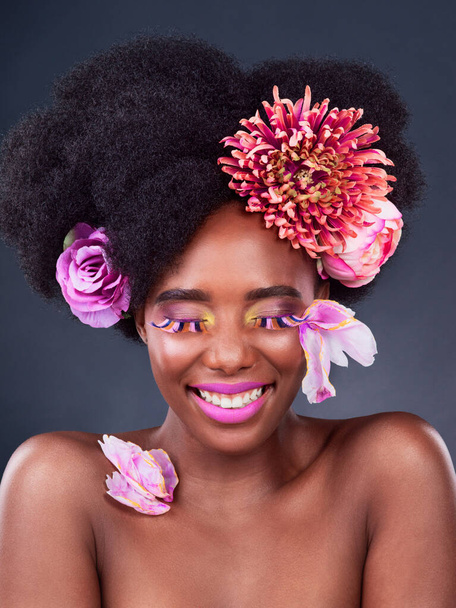 Flowers, makeup and portrait of happy black woman for beauty, creative and spring. Natural, cosmetics and floral with face of female model in studio for aesthetic, self love and organic skincare - Foto, Imagem