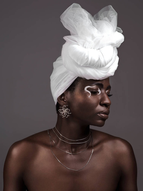 Face, wrap and black woman with makeup, skincare or confidence in studio on grey background. Beauty, profile or proud African model with traditional culture, eyeshadow cosmetics or creative necklace. - Photo, Image