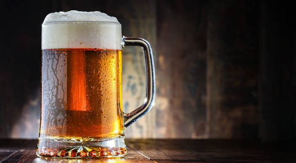 A pint of beer on wooden background. - Photo, Image