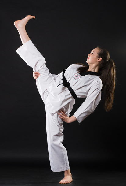 Girl in kimono exercising karate kata - Foto, afbeelding