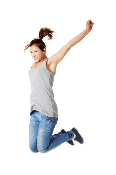 Young happy caucasian woman jumping in the air - Φωτογραφία, εικόνα