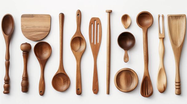 A variety of wooden kitchen utensils neatly displayed on a white background. - Photo, Image