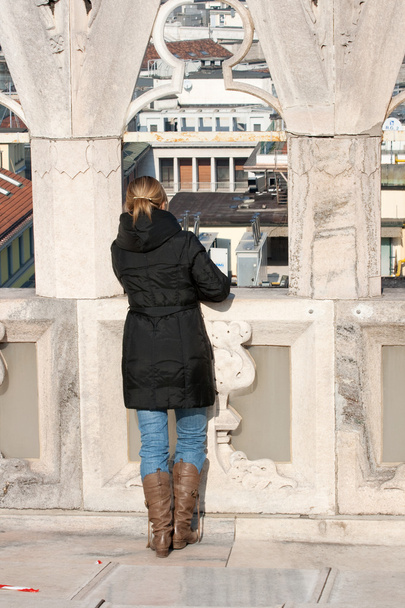 Girl on the railing overlooking, Milan cathedral - Photo, Image