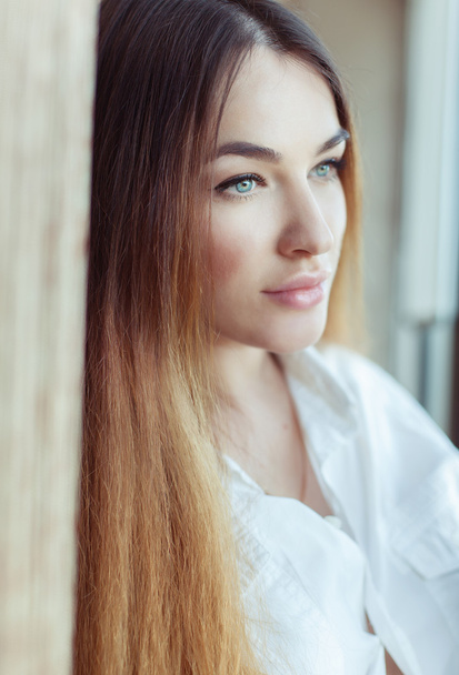 Emotive portrait of beautiful woman with long hair in white shir - Zdjęcie, obraz