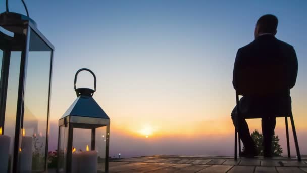 üzleti ember néz napkelte-teraszon - Felvétel, videó