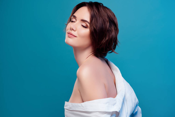 Portrait of lovely dreamy girlfriend with bare shoulder wearing white seductive shirt isolated on blue color background. - Fotoğraf, Görsel