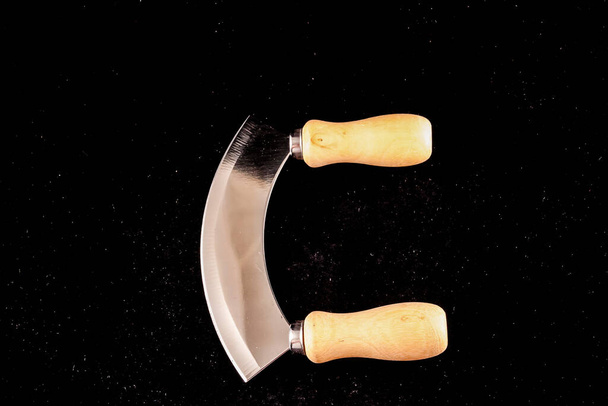 A pair of wooden handles with a curved blade - Photo, Image