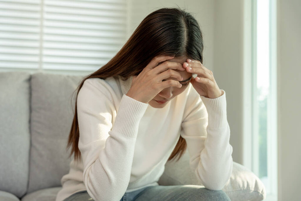 Depression and mental illness. Asian woman disappointed, sad after receiving bad news. Stressed girl confused with unhappy problems, arguing with boyfriend, cry and worry about unexpected pregnancy. - Photo, Image