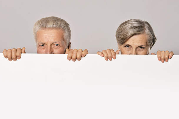 Old couple with board - Фото, зображення