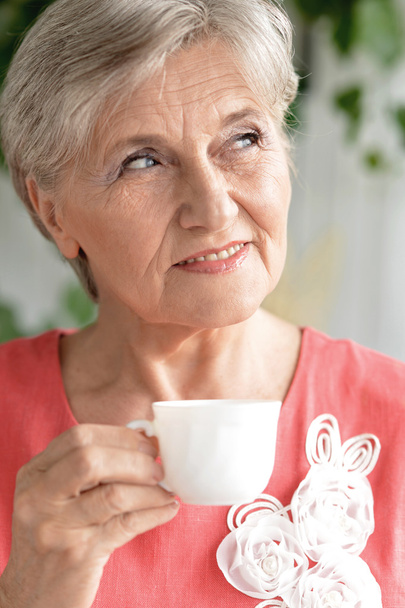 Senior woman with cup of coffee - Fotó, kép