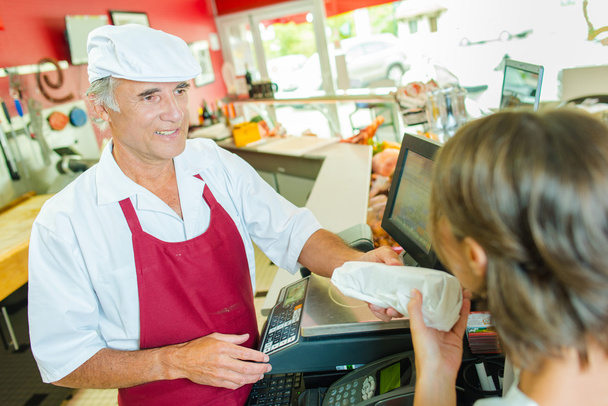 Serving a customer in a deli - Фото, зображення
