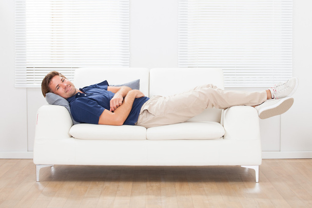Man Lying On Sofa At Home - Fotoğraf, Görsel