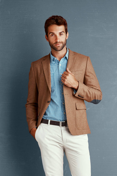 Business, fashion and portrait of man with pride, creative career and professional in studio. Relax, trendy style and businessman on grey background with confidence, opportunity and designer clothes. - Photo, Image