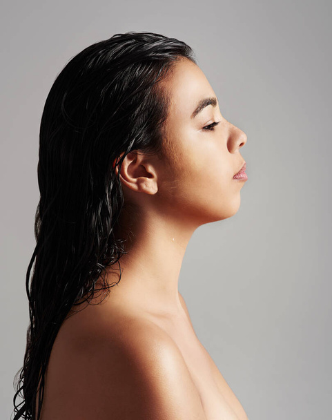 Woman, profile and beauty salon with haircare, cosmetics or shower on a gray studio background. Young female person or model with wet hair for spa wash, hygiene or keratin treatment on mockup space. - Photo, Image
