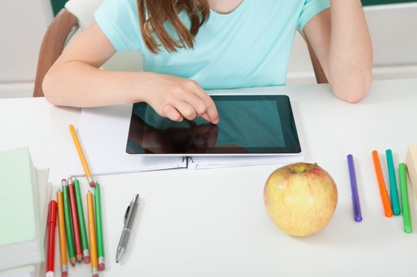 Schoolgirl Touching Digital Tablet - Foto, Imagen