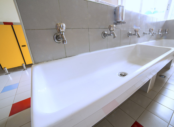 ceramic sink with many taps in the school - Photo, Image