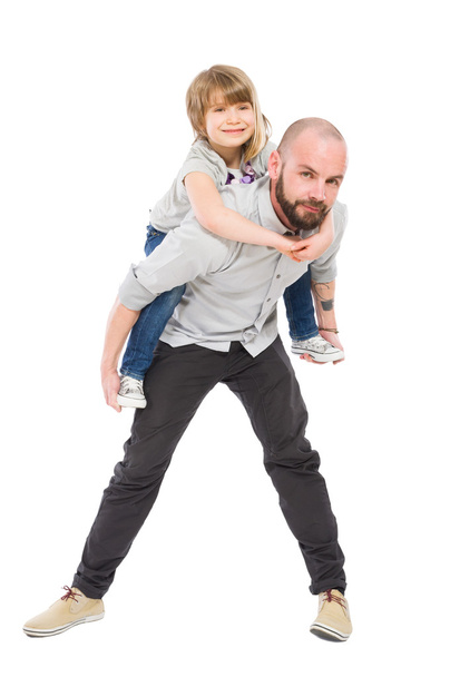 Smiling daughter on father back - 写真・画像