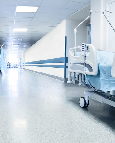 Surgical bed in hospital corridor - Фото, изображение