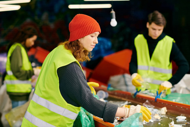 A young woman in a green vest and a man in a black shirt, wearing gloves, sorting trash as eco-conscious volunteers. - Foto, Bild