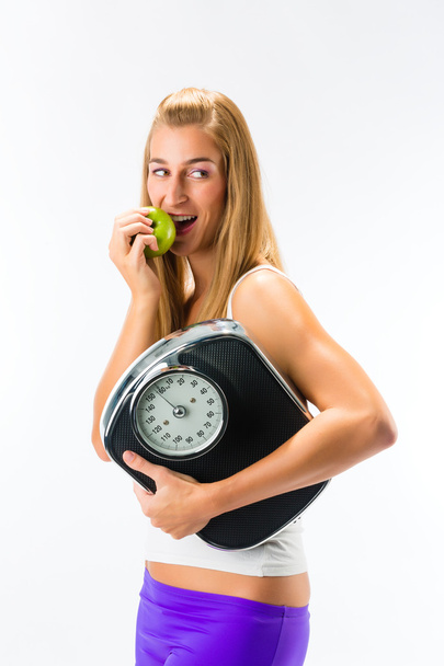 woman with scale  and apple - Foto, Imagen