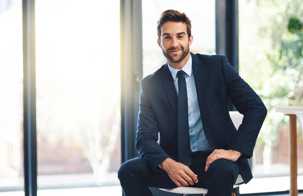 Businessman, pride and chair in office with portrait for ambition, success and career mindset. Corporate person, suit and power in workplace for vision, startup and company mission with happiness. - Photo, Image