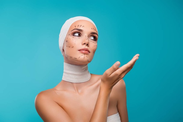 Photo of lady in medical bandage demonstrate hand beauty procedure on adverts cyan empty space background. - Photo, Image
